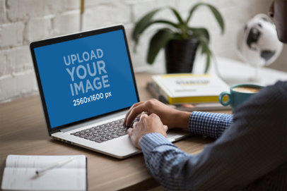 Mockup of a Man Working on His MacBook at Home