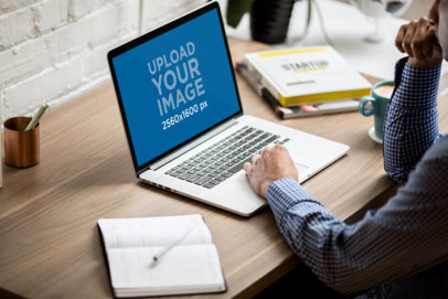MacBook Mockup of a Man Working at a Desk