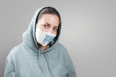 Face Mask Mockup Featuring a Woman in a Studio
