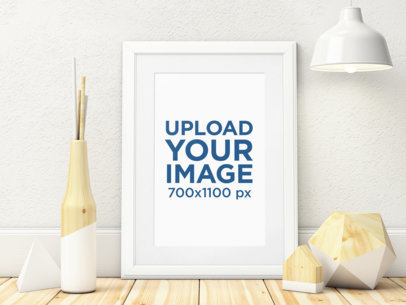 Mockup of an Art Print Placed on a Wooden Surface by Minimal Decorative Items 3968-el1