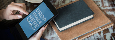 Mockup of a Nexus 7 in Portrait Position Featuring a Man at a Coffee Shop 