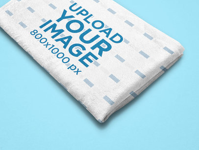 Mockup of a Folded Blanket Featuring a Customizable Background