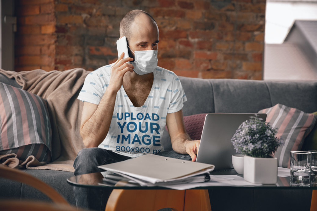 T-Shirt Mockup of a Man with a Face Mask Working From Home