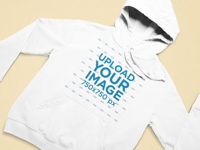 Mockup of a Pullover Hoodie Flat Laid on a Colorful Surface