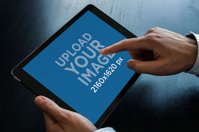 Mockup of a Man Touching an iPad in Landscape Position