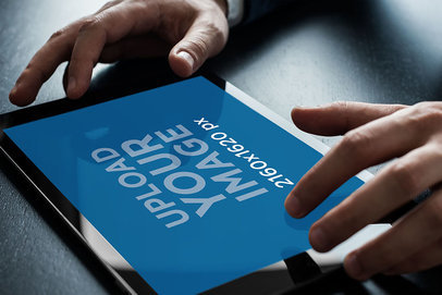 Mockup of an iPad in Landscape Position Being Used by an Adult