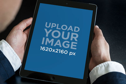 Over The Shoulder Mockup of a Man Holding an iPad in Portrait Position 2041-el1