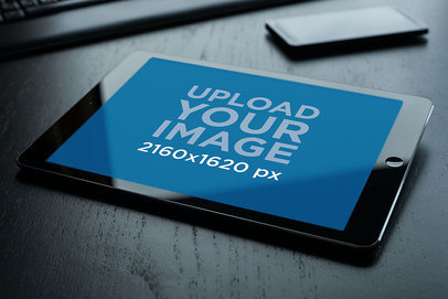 Mockup of an iPad in Landscape Position Placed on a Dark Wooden Surface 2042-el1