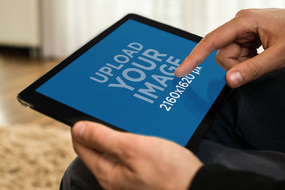 Mockup of a Man Using an iPad in Landscape Position