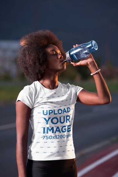 T-Shirt Mockup of a Woman Drinking Water at a Running Track