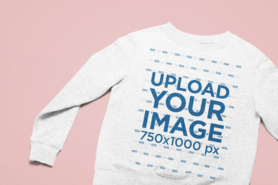 Closeup Mockup of a Heathered Sweatshirt Lying on a Plain Surface