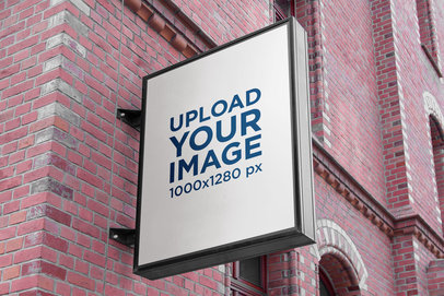 Mockup of a Vertical Sign Placed on a Brick-Wall Facade