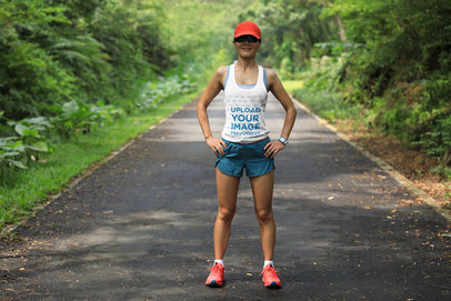 Tank Top Mockup of a Female Runner on a Bushy Road