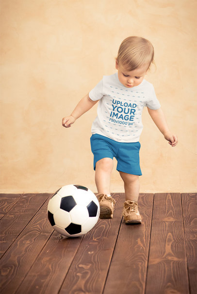 T-Shirt Mockup of a Little Kid Playing with a Soccer Ball