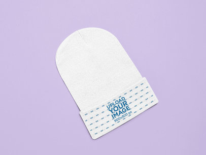 Flat Lay Mockup of a Beanie over a Customizable Surface 25641