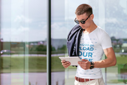 T-Shirt Mockup of a Man with Sunglasses Checking His Tablet 34426-r-el2