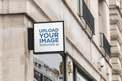 Mockup of a Square Outdoor Sign on a Concrete Building's Corner