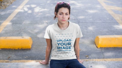 T-Shirt Video of a Young Woman Sitting in a Parking Lot 12152