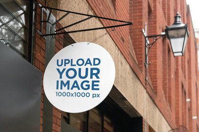 Mockup of a Circular Sign Hanging from a Store 4118-el1