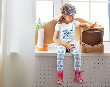 T-Shirt Mockup of a Girl with Leggings Playing with a Cardboard Astronaut Helmet 34576-r-el2