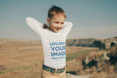 Mockup of a Kid Wearing a Long Sleeve Tee at a Meadow