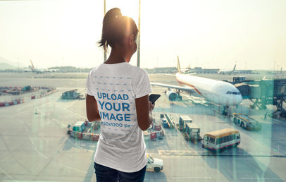 Back View Mockup of a Woman Wearing a T-Shirt at the Airport 34560-r-el2