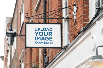 Mockup of an Outdoor Store Sign Placed on a Brick Facade