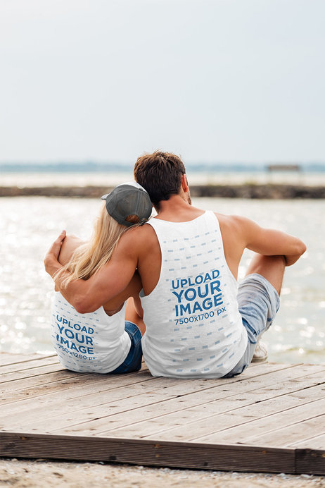 Back View Mockup of a Couple with Tank Tops Hugging at The Beach