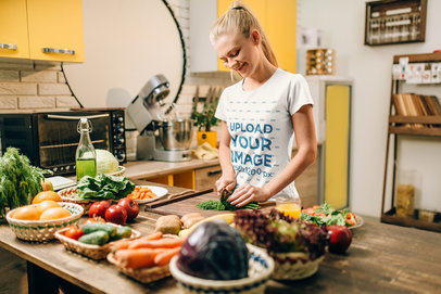 T-Shirt Mockup Featuring a Woman Making Dinner in Her Kitchen