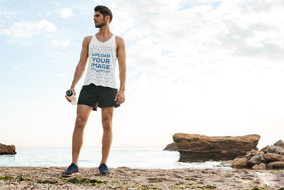 Front View Mockup of a Man Wearing a Tank Top on the Beach 