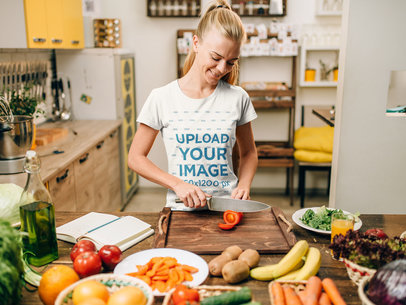Mockup of a Happy Woman with a T-Shirt Cooking in the Kitchen