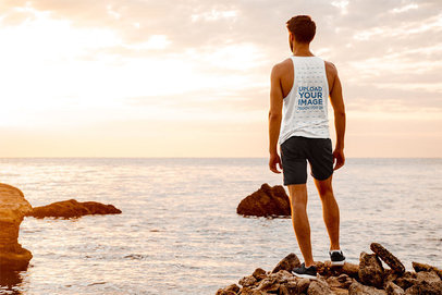 Back View Mockup of a Man with a Tank Top Looking at the Ocean