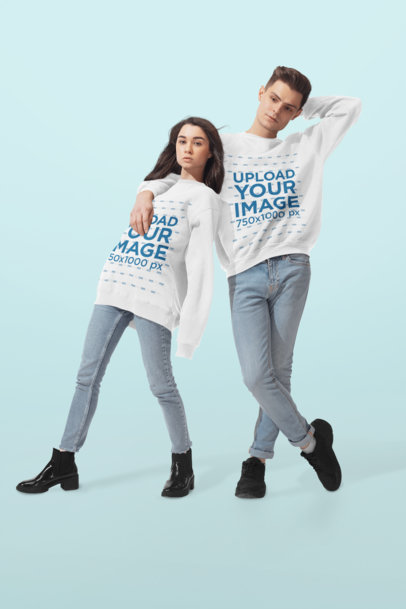Mockup of Two Friends with Oversized Sweatshirts Posing at a Studio 
