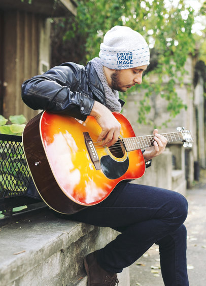 Beanie Mockup Featuring a Man Playing the Guitar Outside