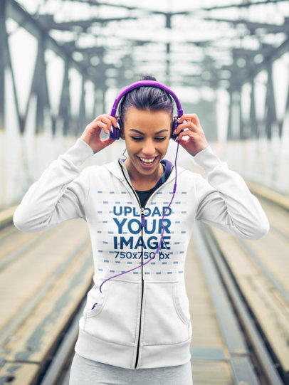 Mockup of a Jogger with Headphones Wearing a Full-Zip Hoodie