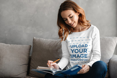 Long Sleeve Tee Mockup Featuring a Woman Taking Notes on Her Couch