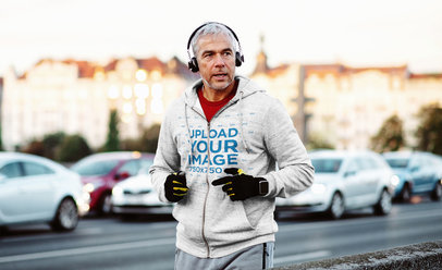 Mockup of a Senior Man with a Heathered Full-Zip Hoodie Jogging on the Street