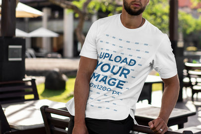 Cropped Face Mockup of a Man with a T-Shirt Leaning on a Chair 