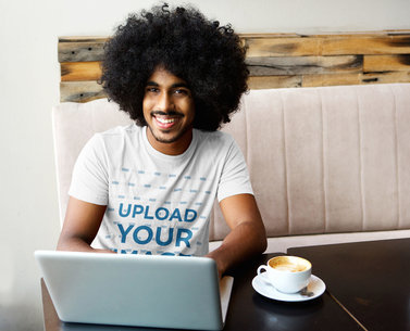 T-Shirt Mockup of a Young Man in a Cafe