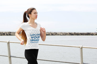 V-Neck Tee Mockup of a Female Jogger by a Pier 