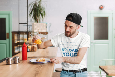 T-Shirt Mockup Featuring a Man Eating a Hamburger 