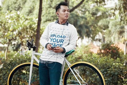 Mockup of Man with a Crewneck Sweatshirt Leaning on His Bike