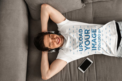 T-Shirt Mockup of a Man Listening Music Laid on His Couch