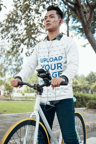 Crewneck Sweatshirt Mockup of a Man Riding a Bike in the Park
