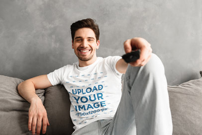 T-Shirt Mockup of a Man on a Couch Holding a Remote Controller 34522-r-el2