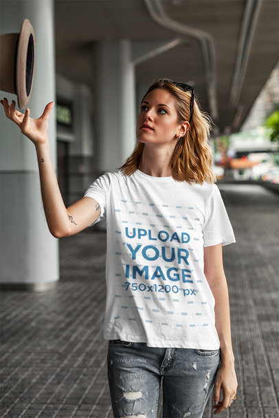 T-Shirt Mockup of a Young Woman Playing with a Hat
