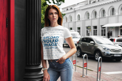 Mockup Featuring a Woman Wearing a Customizable Tee by a Street 