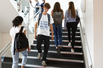 T-Shirt Mockup of a Teenager Walking Down College Stairs