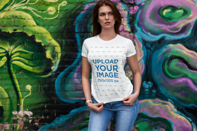 T-Shirt Mockup Featuring a Woman and Graffiti in the Background