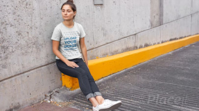 T-Shirt Video of a Woman Sitting By a Parking Lot Ramp 12892
